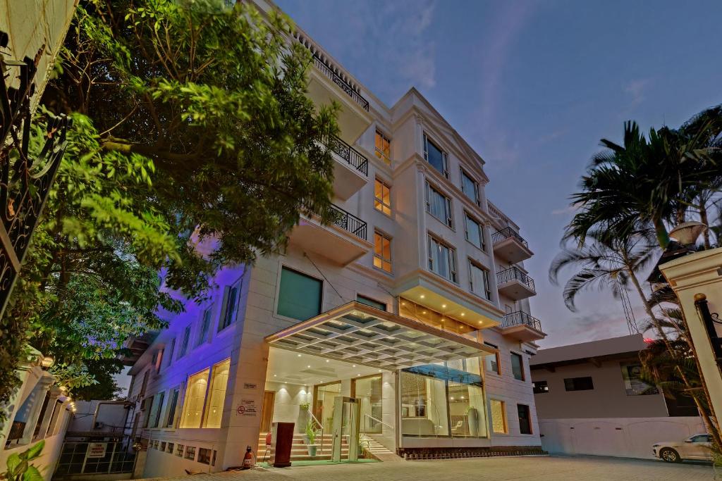 an exterior view of a hotel with a building at The Fern Residency Hubballi in Hubli