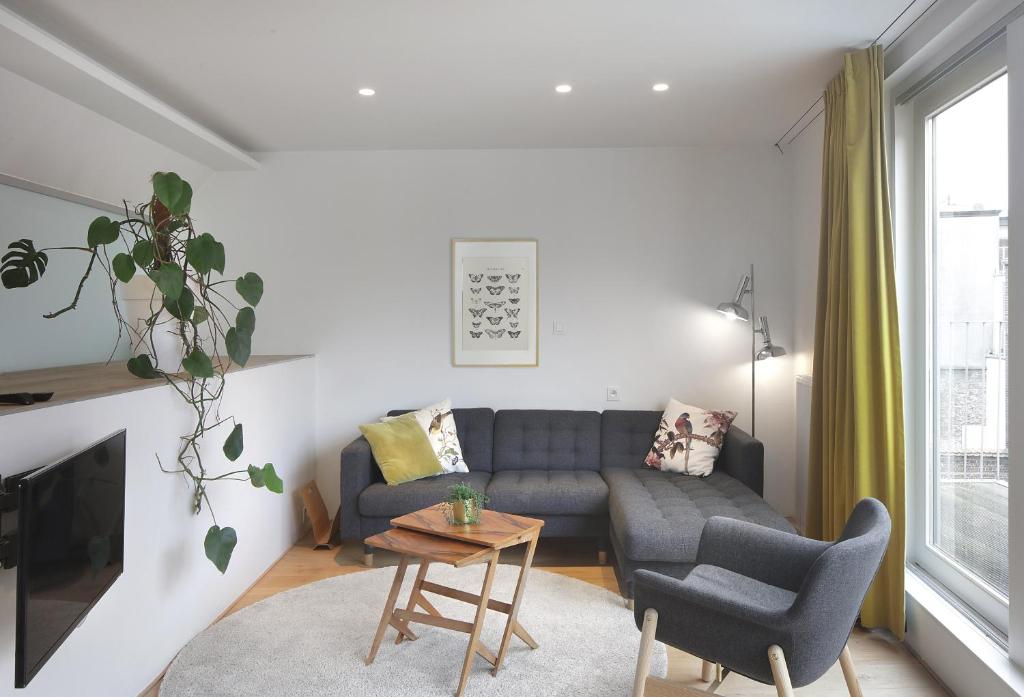 uma sala de estar com um sofá e uma mesa em Loftsuite em Gent