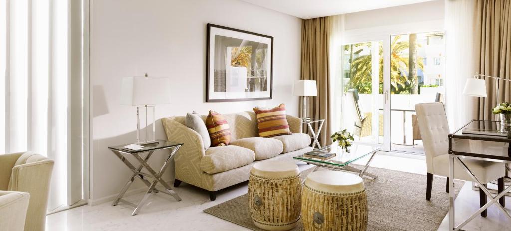 a living room with a couch and a table at Puente Romano Marbella in Marbella