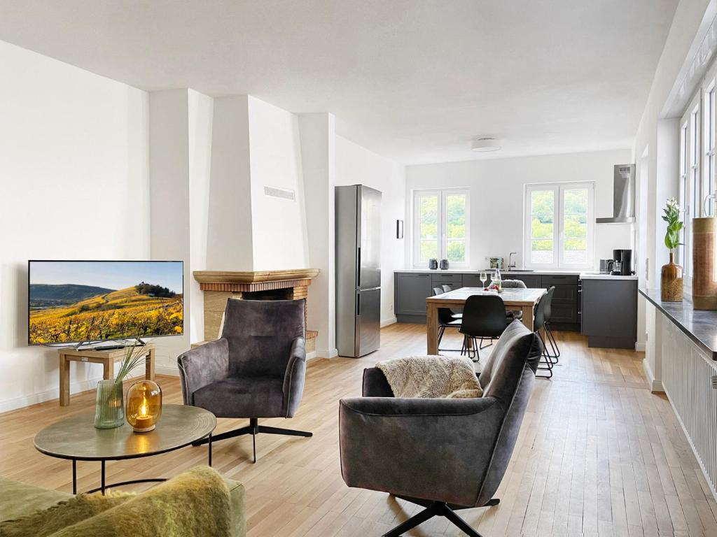 a living room with a couch and chairs and a table at Villa Burglay Ferienwohnungen mit und ohne Sauna in Zell an der Mosel