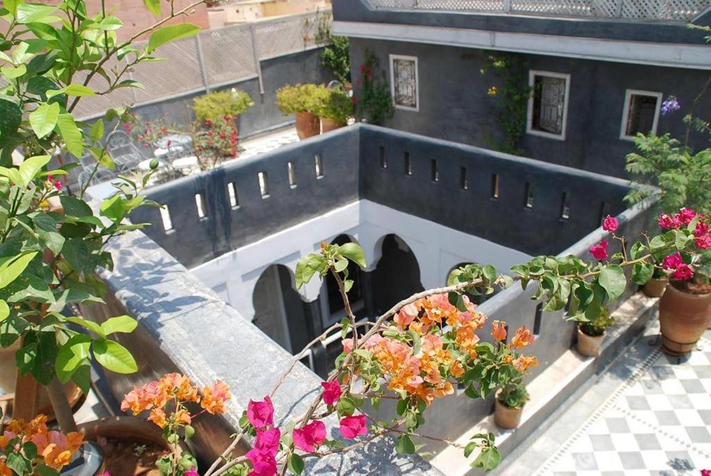 a group of potted plants and flowers on a balcony at Riad Green Palm in Marrakesh