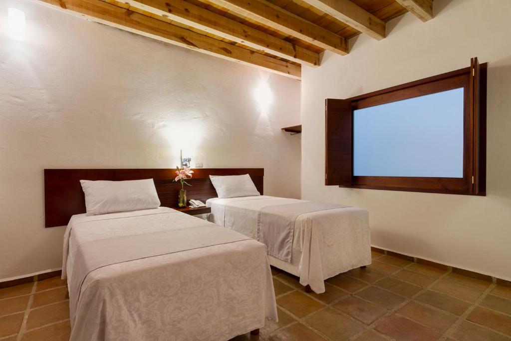 Postel nebo postele na pokoji v ubytování Hotel Casa Real Del Café