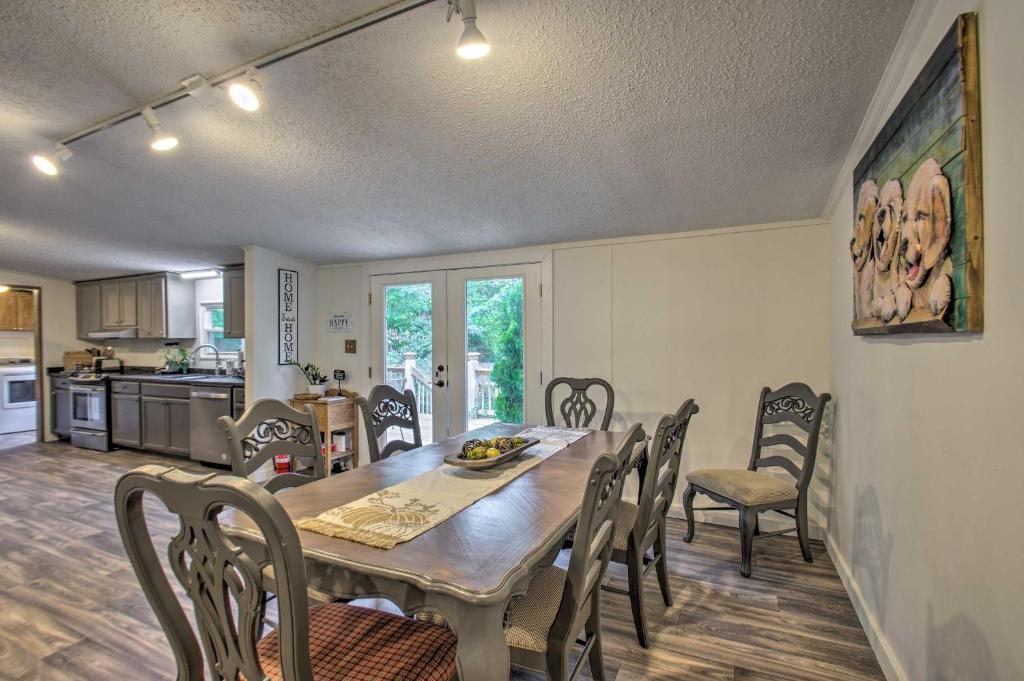 a kitchen and dining room with a table and chairs at Spacious Home 10 Miles to Wintergreen Resort! in Nellysford