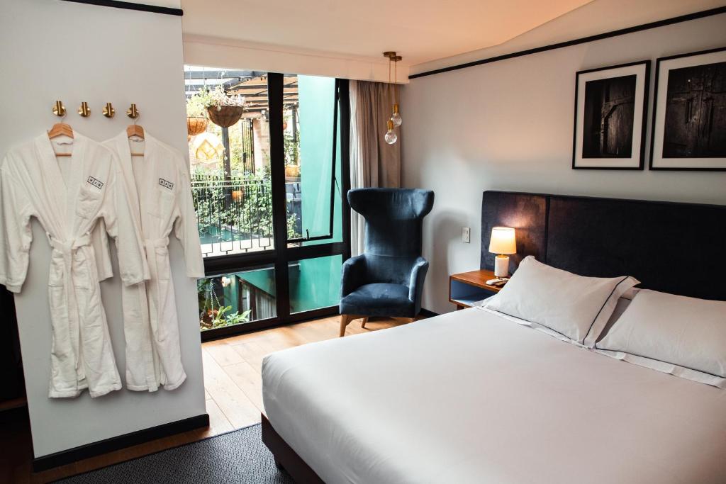 Postel nebo postele na pokoji v ubytování HAB Hotel Bogotá