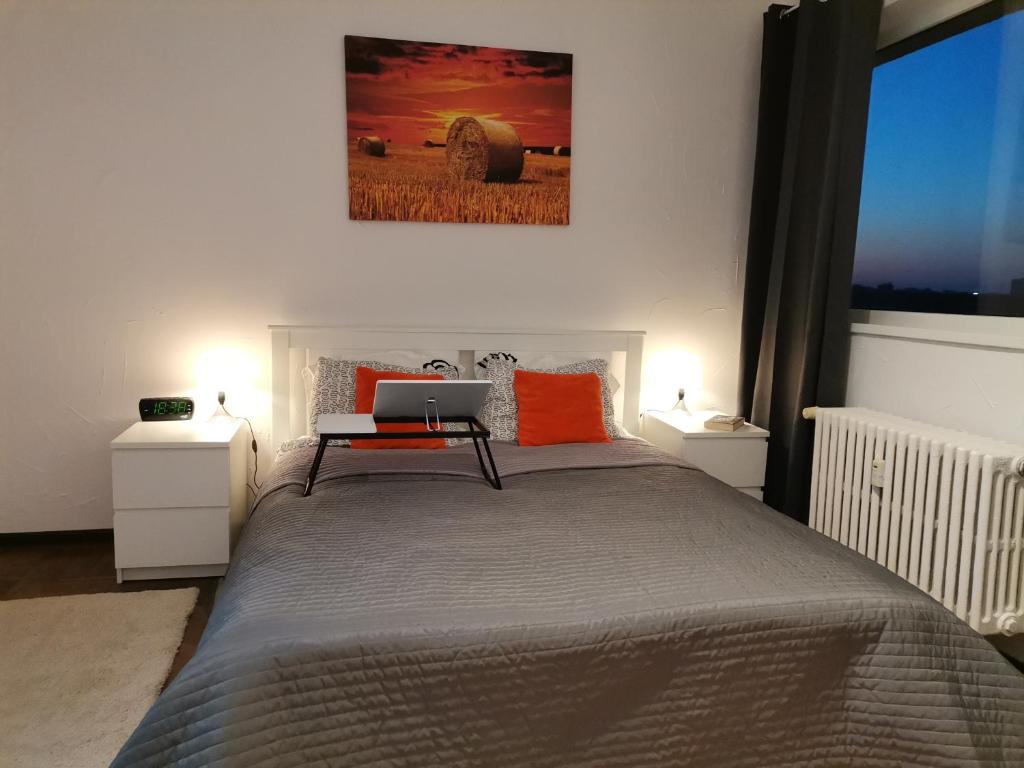 a bedroom with a bed with a laptop on it at STUDIO Piata Victoriei (Victoriei Square) in Bucharest