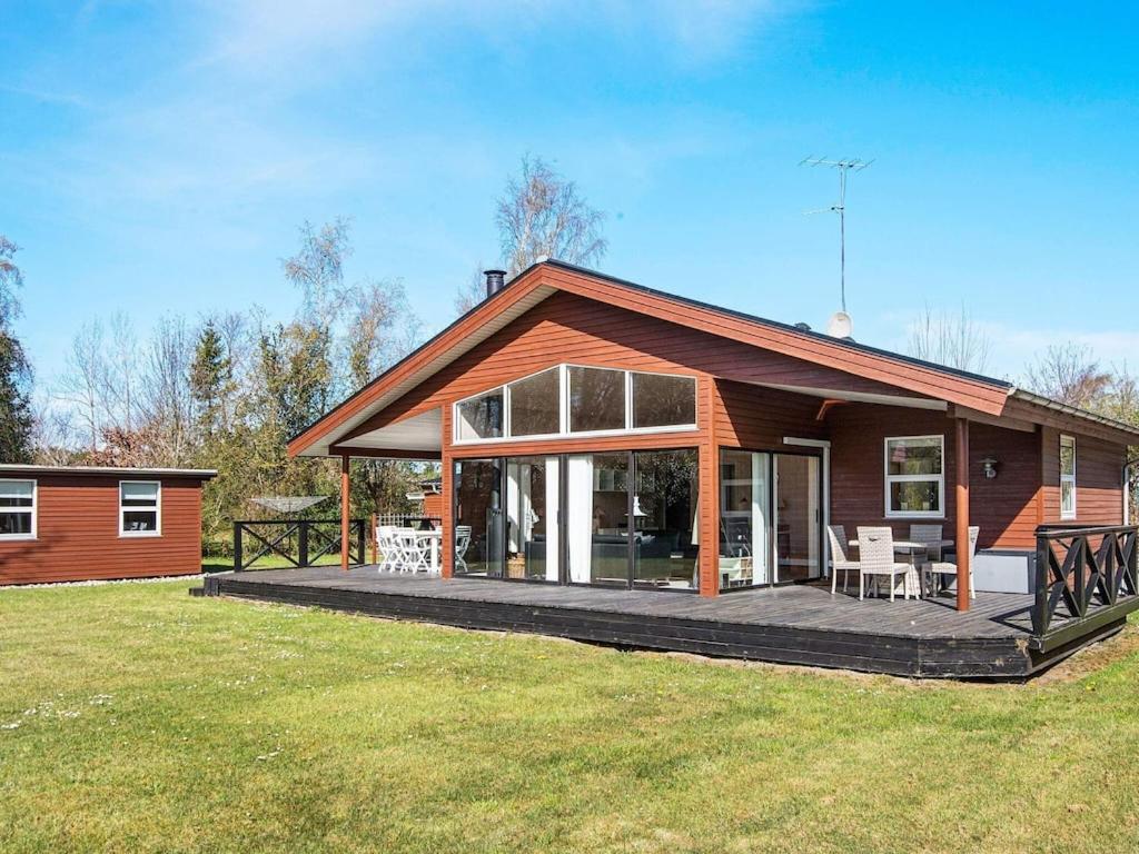 a home with a large deck and a house at 8 person holiday home in Glesborg in Glesborg