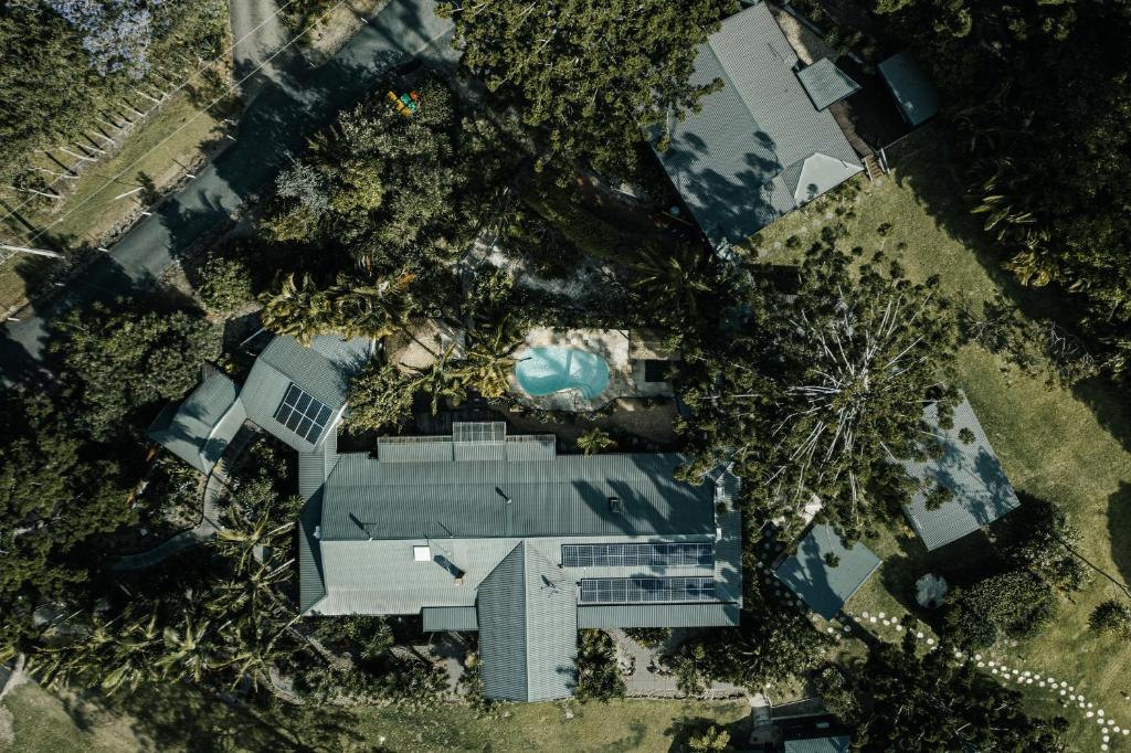 a large building with trees at Cape Byron Retreat (Adults-Only) in Byron Bay
