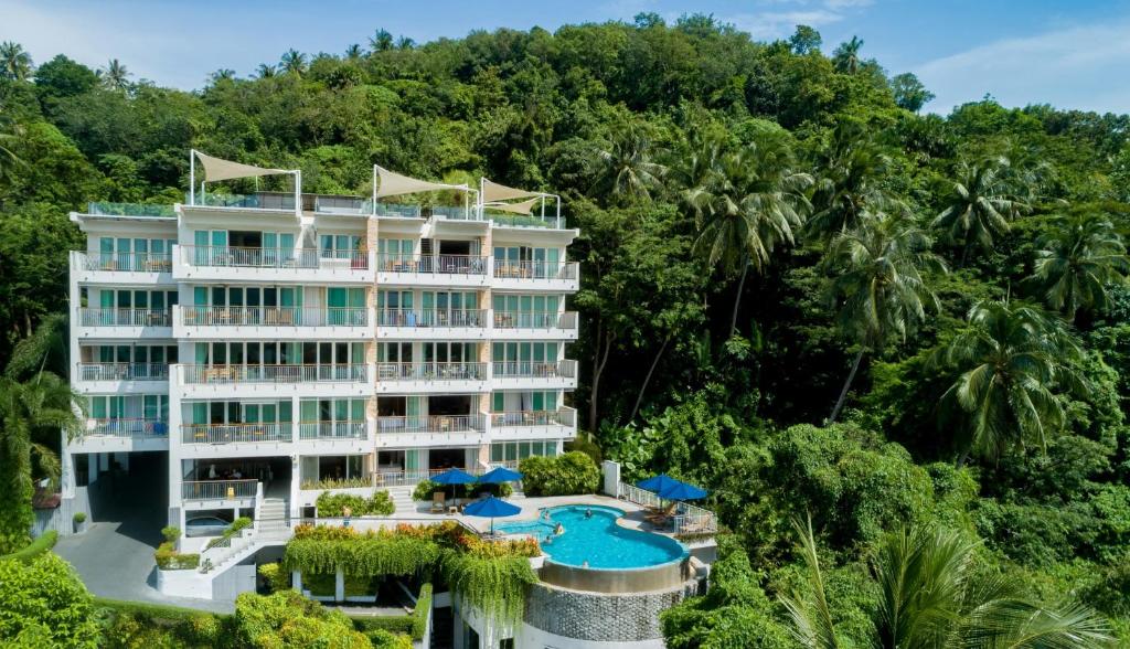 an aerial view of a resort with a pool and trees at The Park Surin Serviced Apartments in Surin Beach
