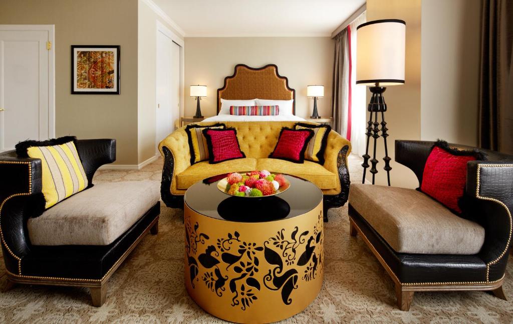 a living room with a bed and a table and chairs at Huntington Hotel in San Francisco