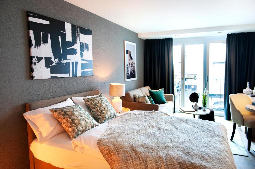 Postel nebo postele na pokoji v ubytování COSMOPOLITAN APARTMENTS Zürich Seefeld