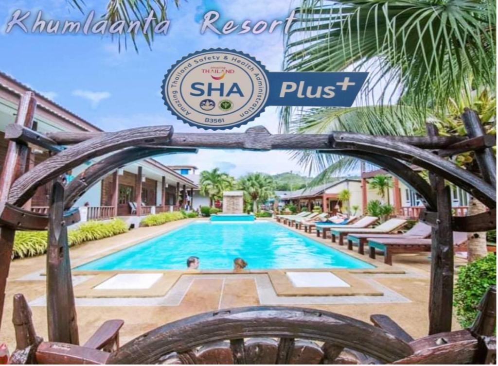 a swimming pool with a clock on top of it at Khum Laanta Resort - SHA Extra Plus in Ko Lanta
