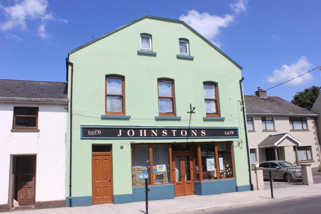 a building on the corner of a street at Johnston House: Historic Village Retreat in Kinvara