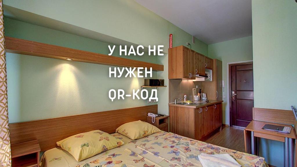 a bedroom with a bed and a sign on the wall at Nevsky 78 Apart-hotel in Saint Petersburg