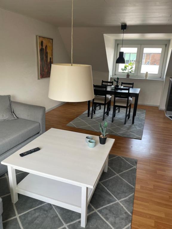 a living room with a couch and a table at Centrum lejlighed in Viborg