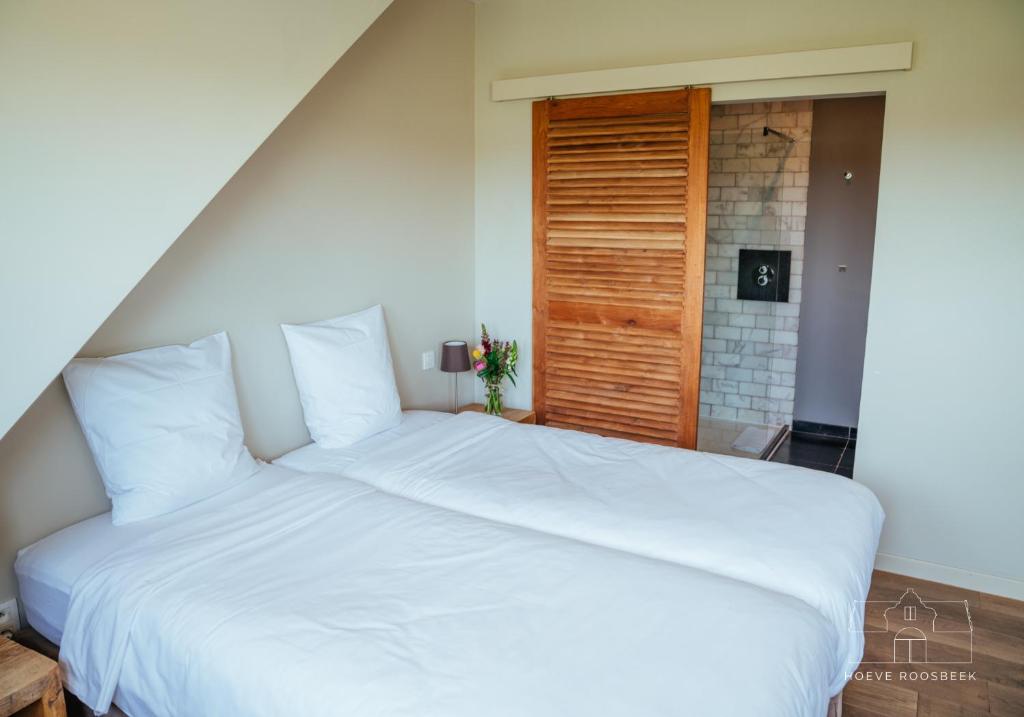 Postel nebo postele na pokoji v ubytování Hoeve Roosbeek