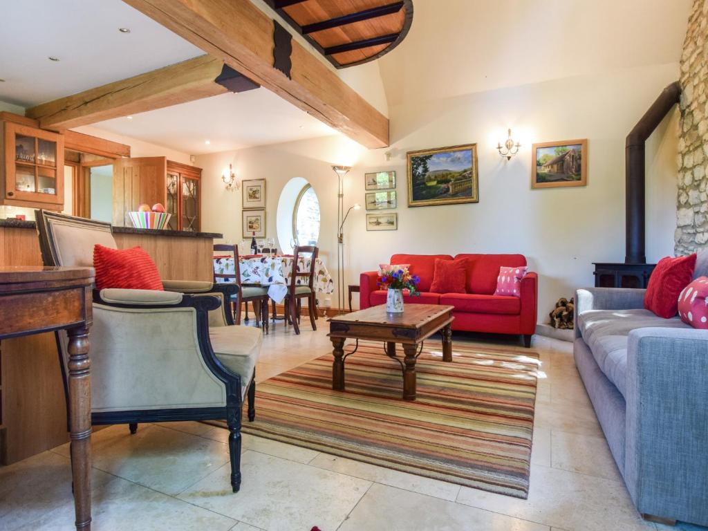 a living room with a couch and a table at The Stables, Batheaston in Batheaston