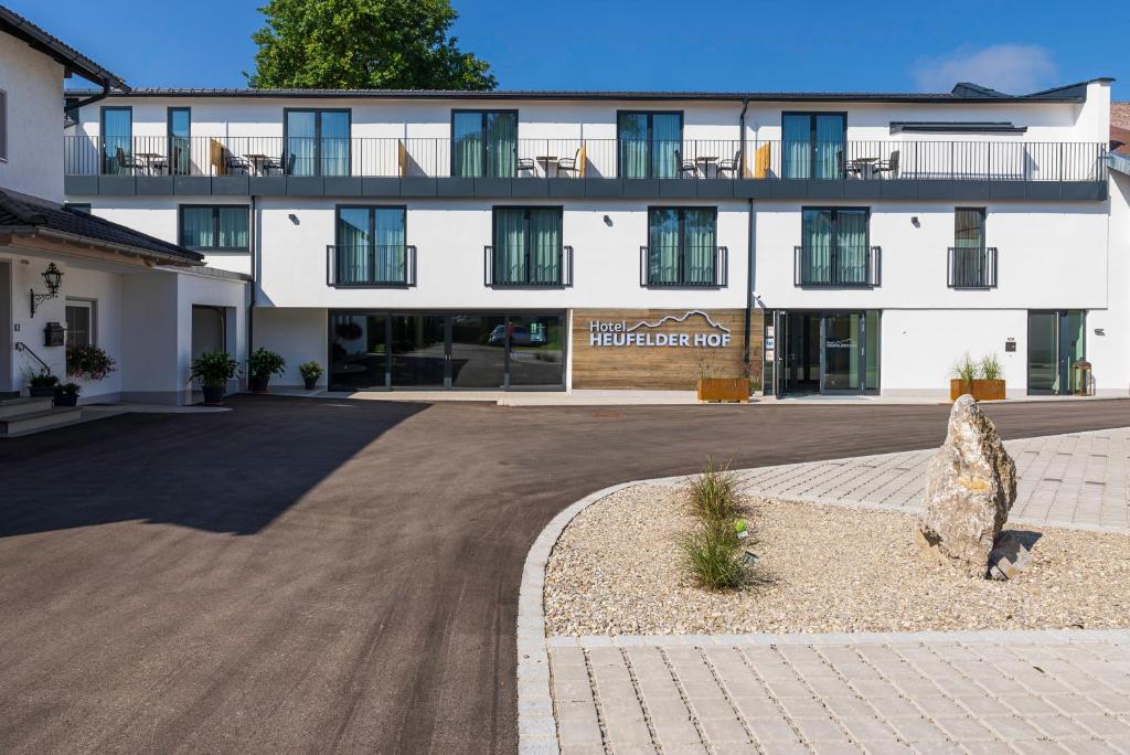 a large white building with a courtyard in front of it at Heufelder Hof in Bruckmühl