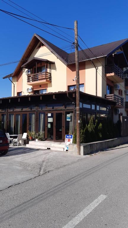 a building on the side of a street with a street at Vila Teju Valeni in Vălenii de Munte