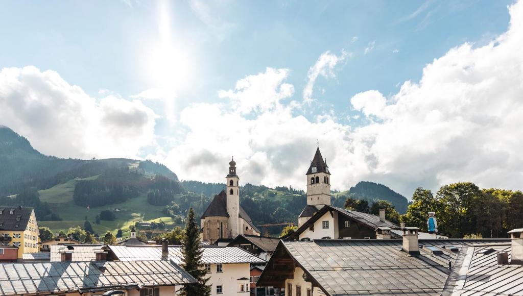 a view of a town with buildings and a church at Hornhaus in Kitzbühel