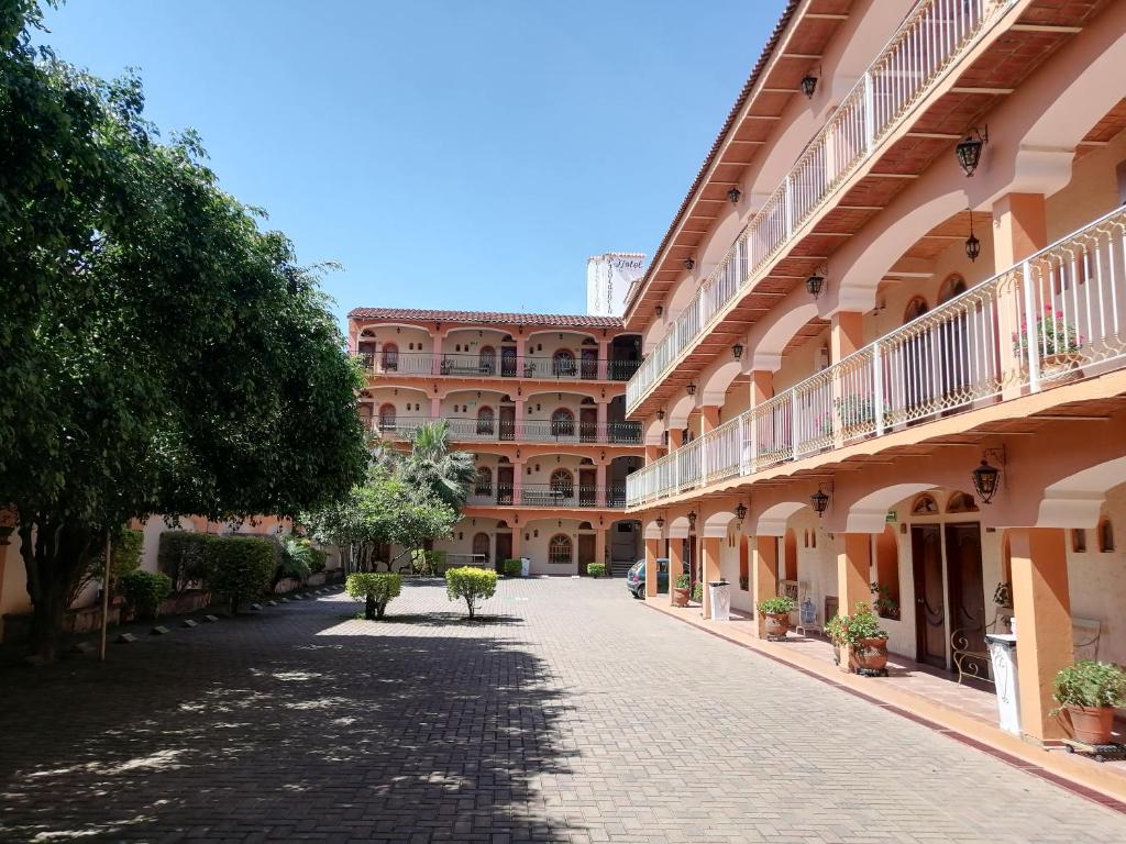 an empty street in front of a large building at Hotel Providencia in Talpa de Allende