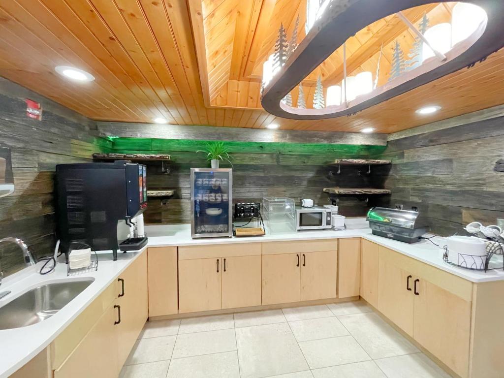 a kitchen with a sink and a counter top at Baymont by Wyndham Gatlinburg On The River in Gatlinburg