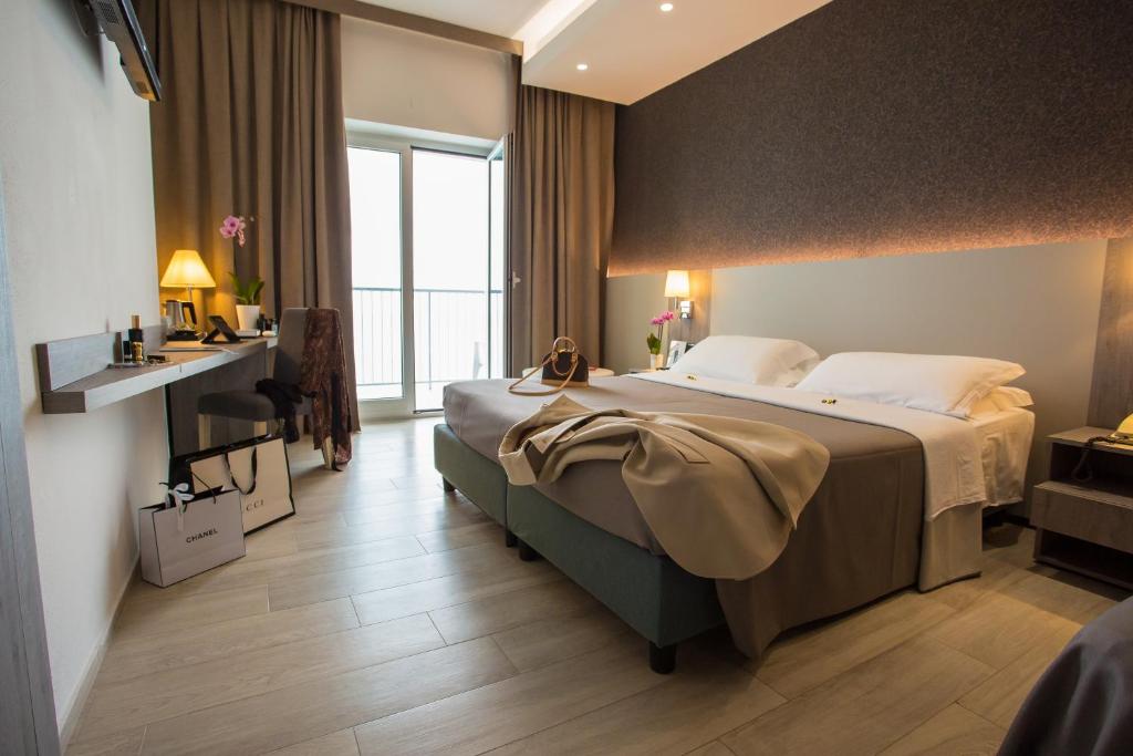 A bed or beds in a room at Hermitage Hotel