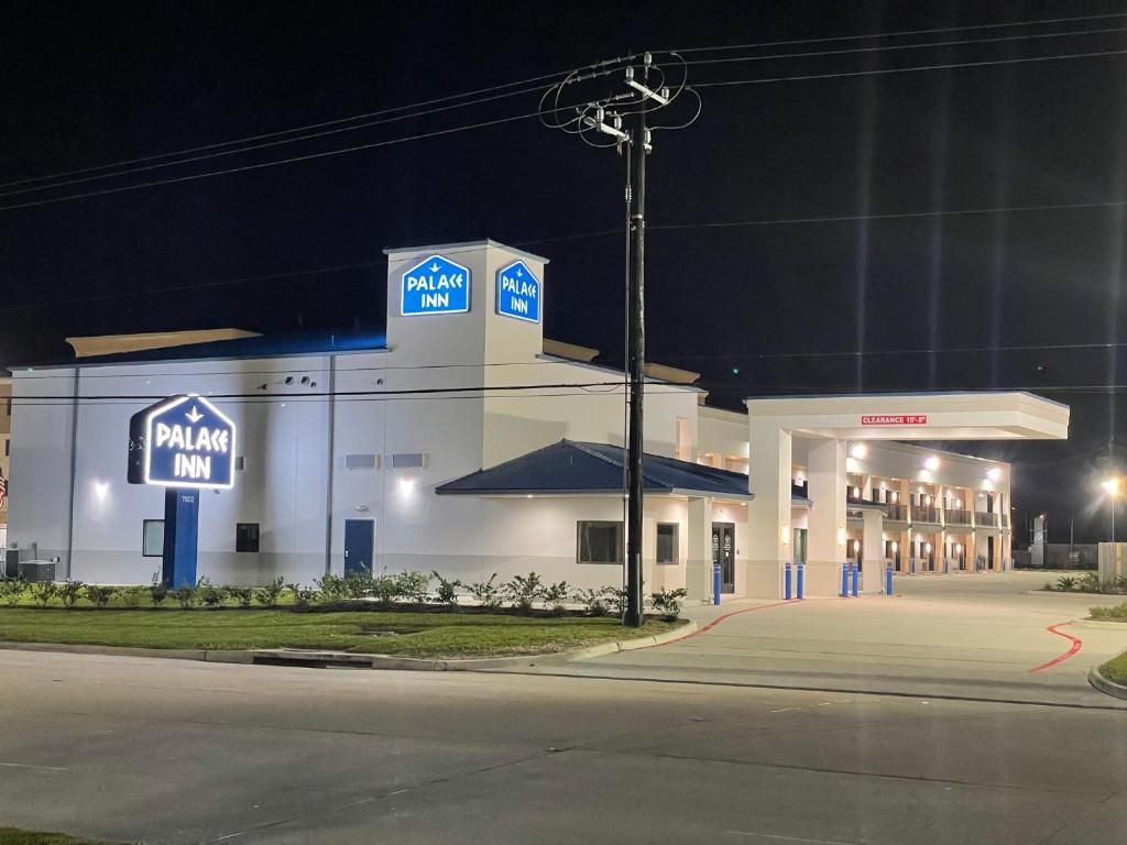 a mobil oil gas station at night with a street at Palace Inn Blue - Garth Rd in Baytown