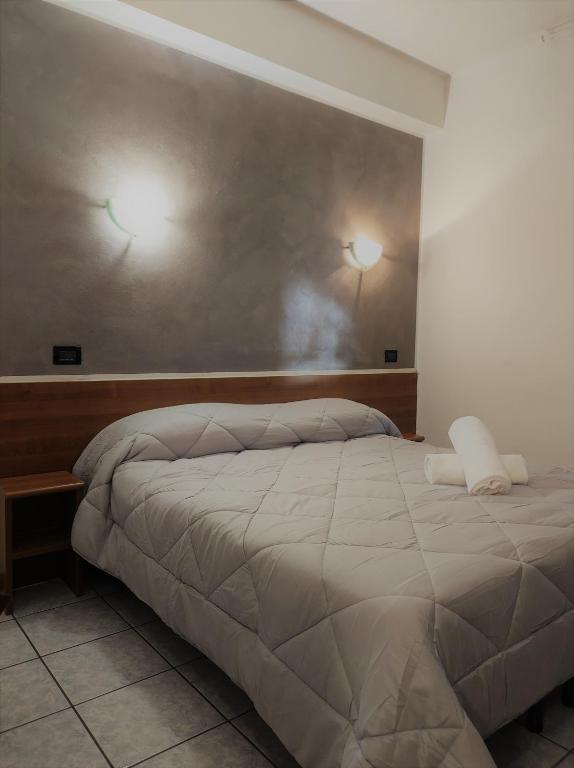 Postel nebo postele na pokoji v ubytování Hotel Marinoni