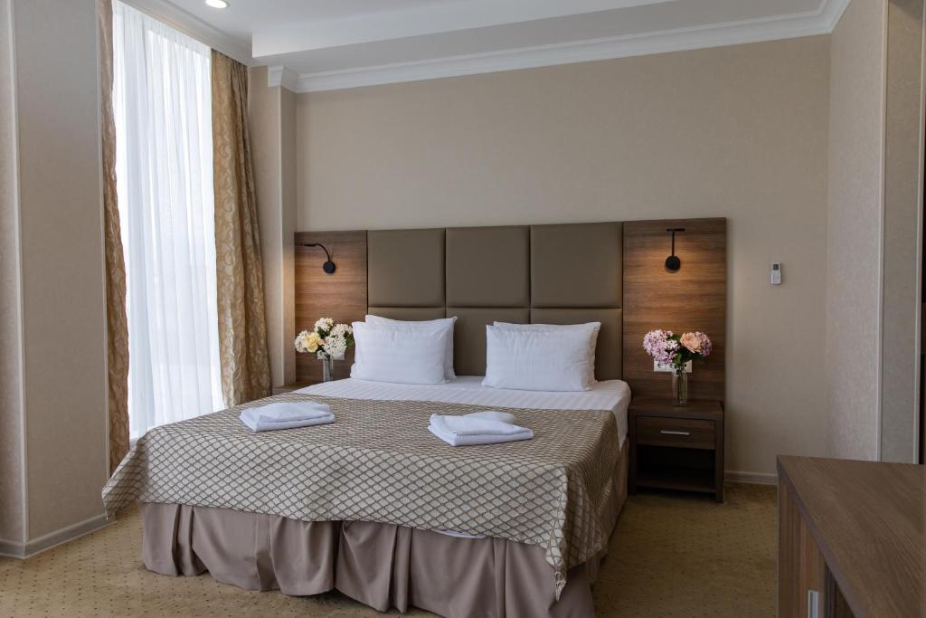 Postel nebo postele na pokoji v ubytování TiAdele Hotel