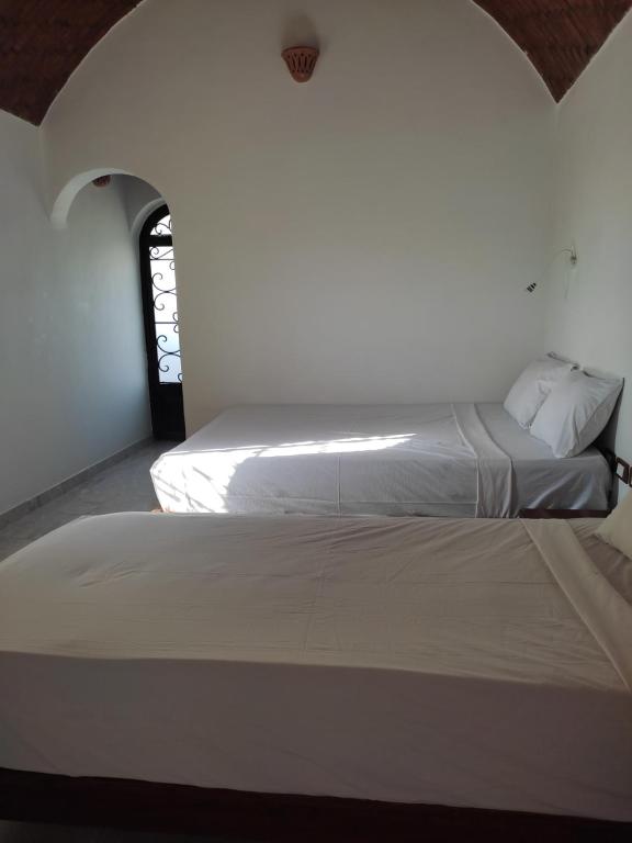 Postel nebo postele na pokoji v ubytování Nubian Holiday House Aswan