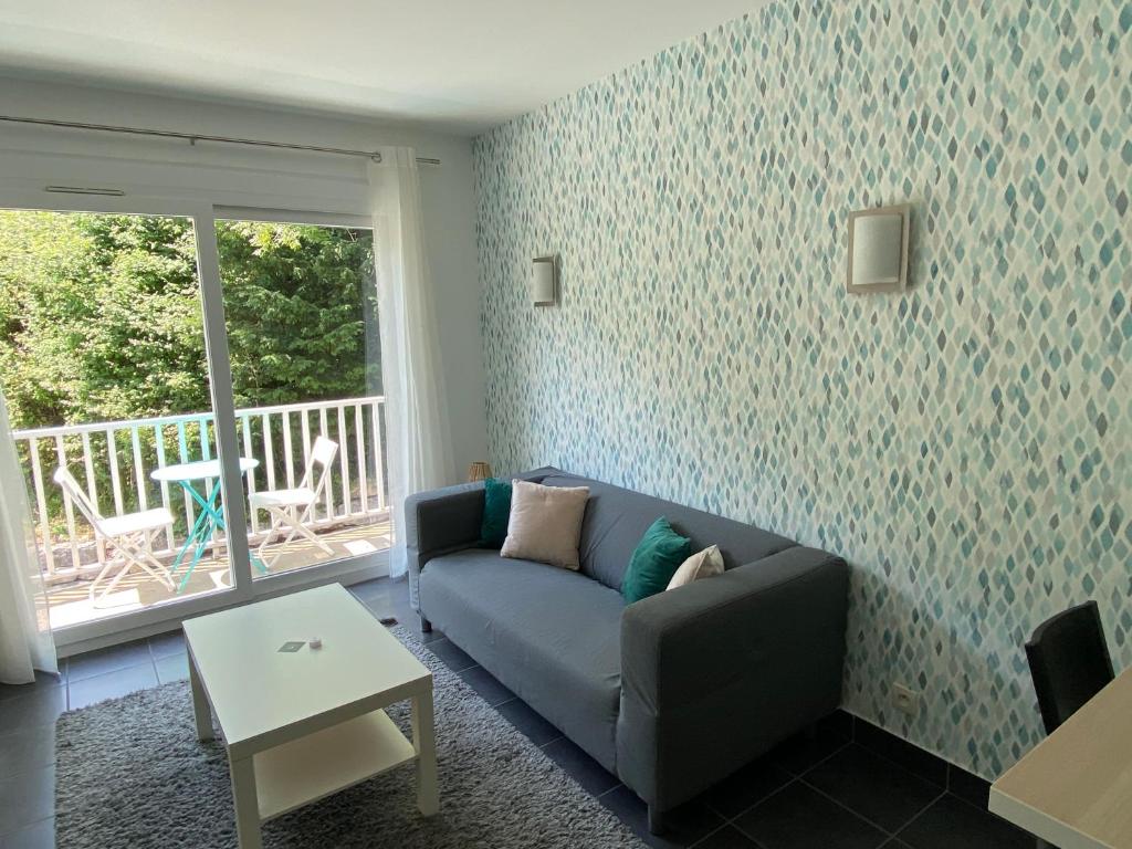 - un salon avec un canapé et une table dans l'établissement PETIT NID AU BOURGET DU LAC, au Bourget-du-Lac