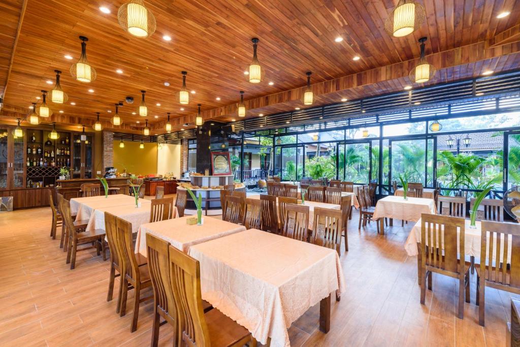a dining room with tables and chairs in a restaurant at Qualia Resort Phu Quoc in Phú Quốc