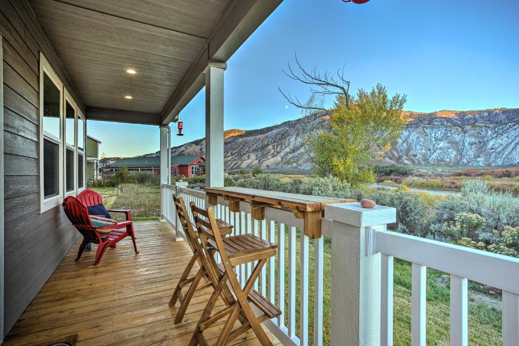 a porch with chairs and a table with a view of a mountain at Magnificent Gypsum Retreat on the Colorado River! in Gypsum