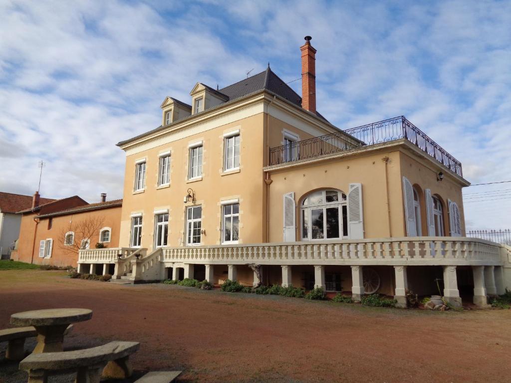 a large yellow building with a balcony on top of it at DOMAINE BERENGUER in Ouches