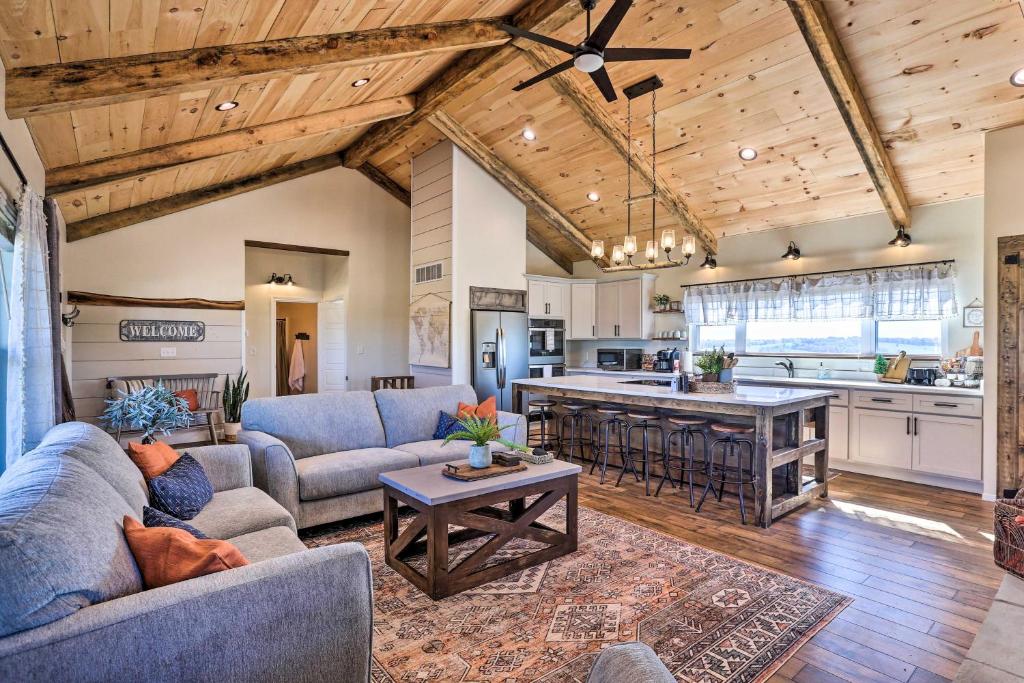 a living room with two couches and a kitchen at Chic Williamstown Retreat with Pool and Hot Tub! in Williamstown