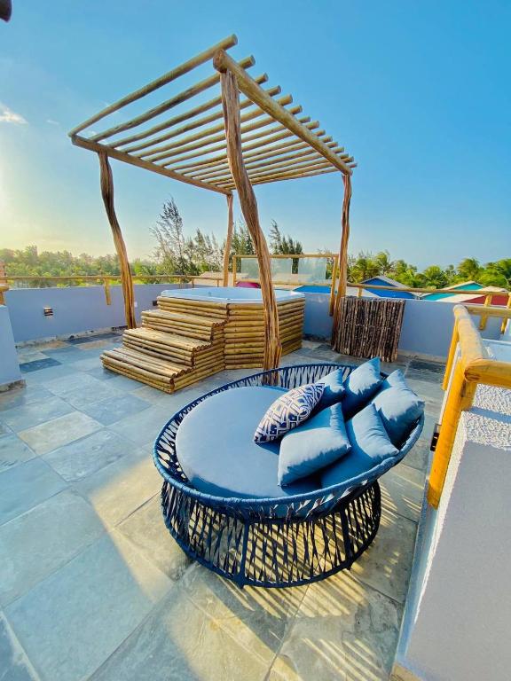 a patio with blue chairs and a gazebo at Pousada Sole - D3 Experience - Preá, CE in Prea