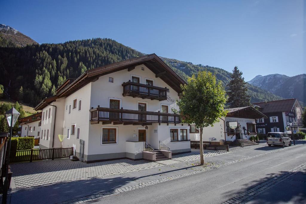 a large white building on the side of a street at Pension Inge in Sankt Anton am Arlberg