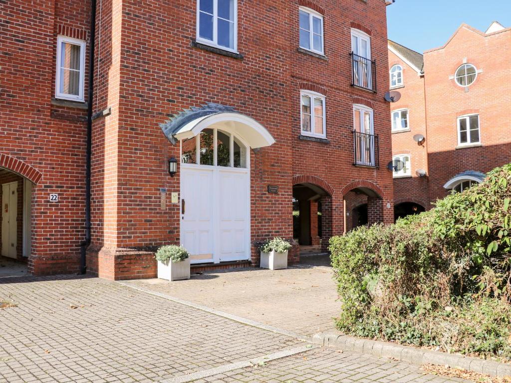 a brick building with a white door on it at 19 Quayside Walk in Southampton