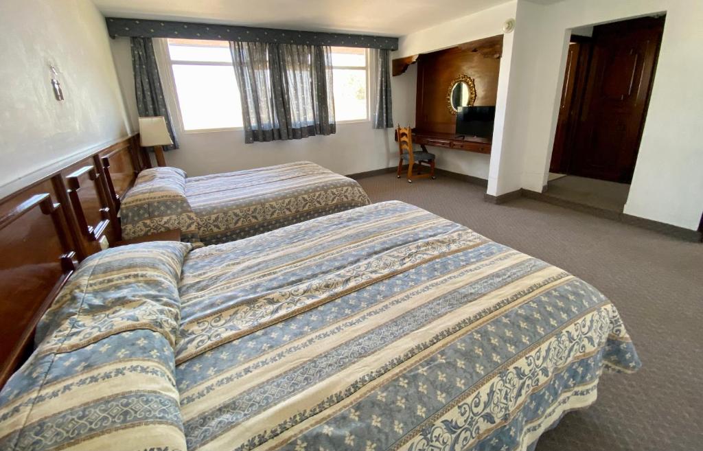Postel nebo postele na pokoji v ubytování Hotel Posada Vista Bella