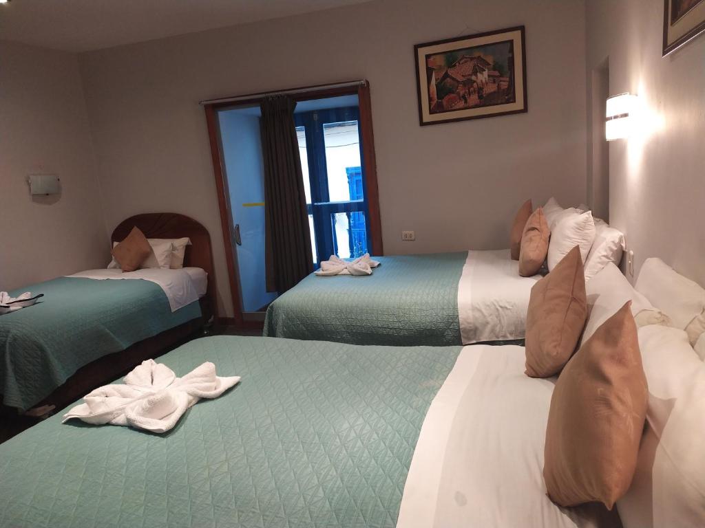 Postel nebo postele na pokoji v ubytování HOTEL AMTALLPA San Blas Inn