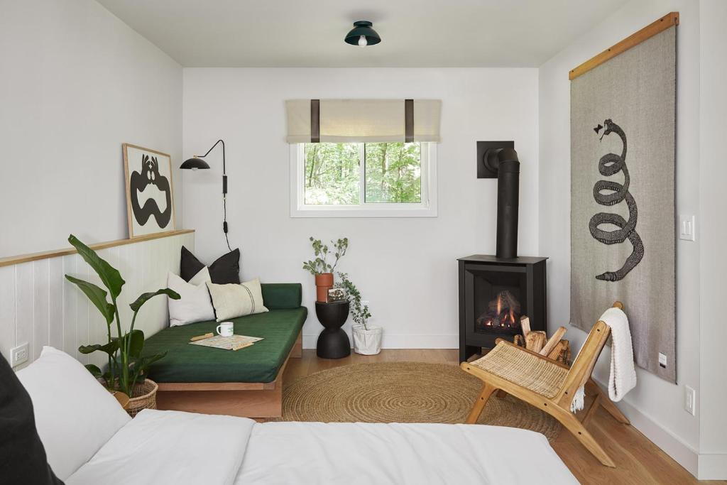 a living room with a couch and a fireplace at Somewhere Inn Calabogie in Calabogie