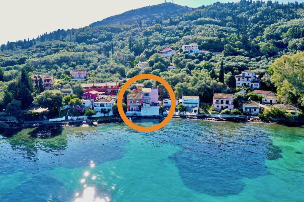 an orange circle in the water next to a city at SeaFront Villa Ourania in Mesongi
