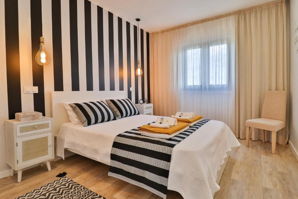 Uma cama ou camas num quarto em Janela Mar VIP