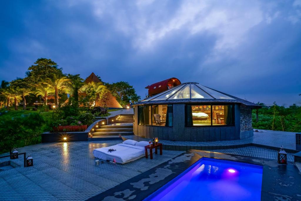 a villa with a swimming pool and a house at Anchaviyo Resort in Vāda
