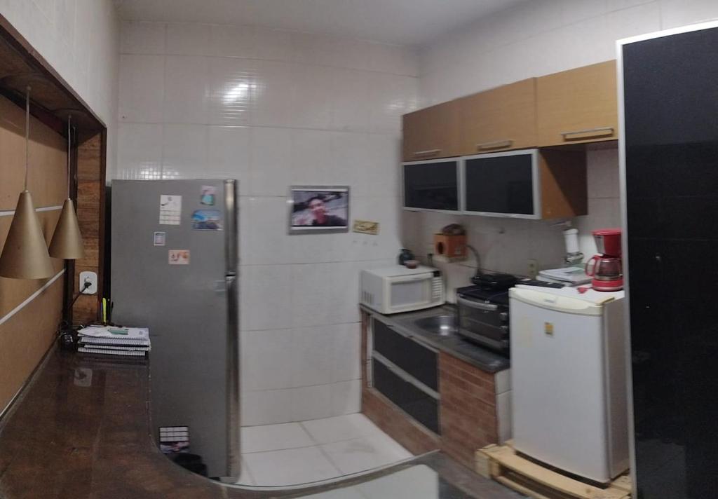 A kitchen or kitchenette at Lar do Aconchego loft