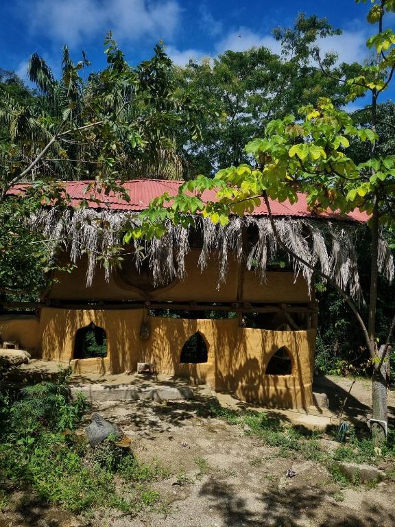 ein altes Haus mit rotem Dach in der Unterkunft Sol de Minca Eco Lodge in Minca