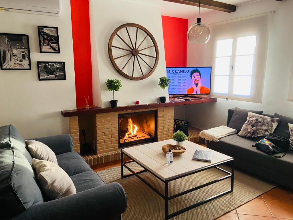 a living room with a couch and a fireplace at Apartamento Rural La Bandolera in El Bosque