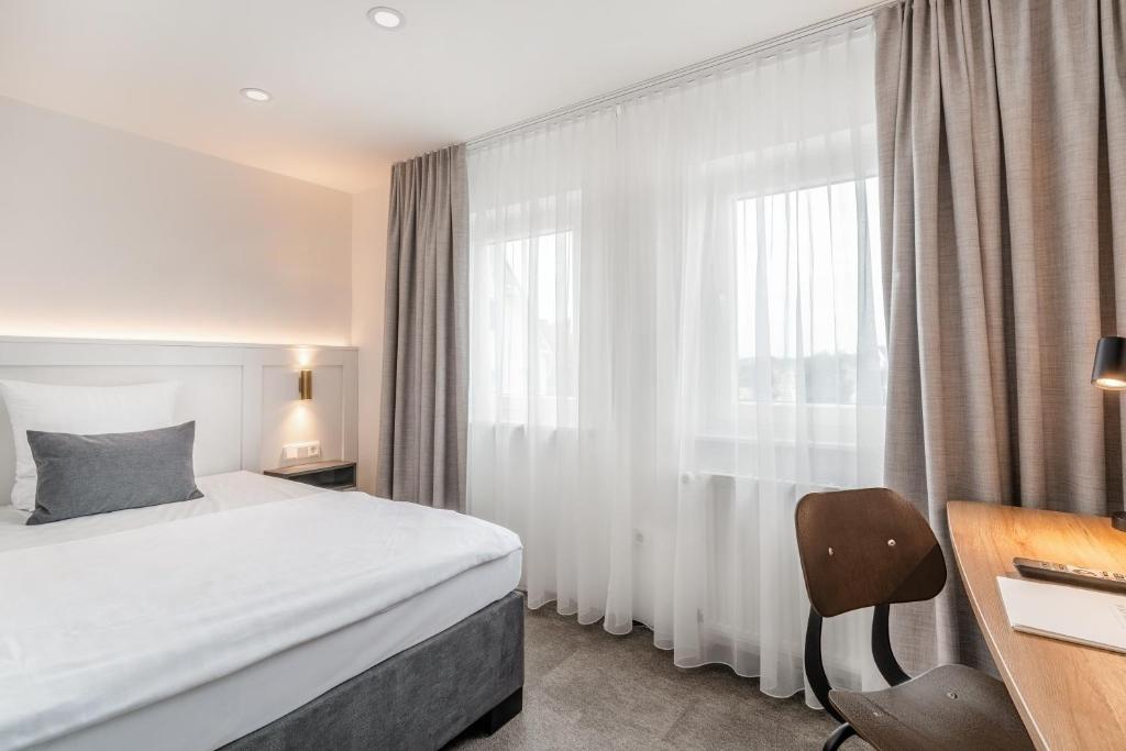 Postel nebo postele na pokoji v ubytování Hotel Bad Minden