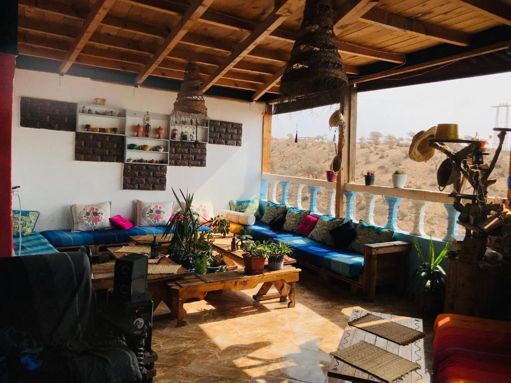 a living room with a blue couch and a table at Rayane Guest House in Taghazout