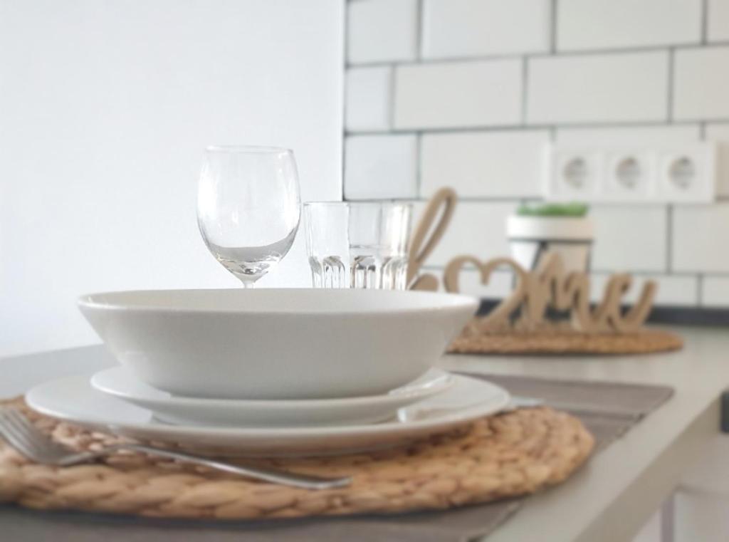 a table with a bowl and glasses on a counter at Tamaran 106 Vv Maspalomas in Playa del Ingles